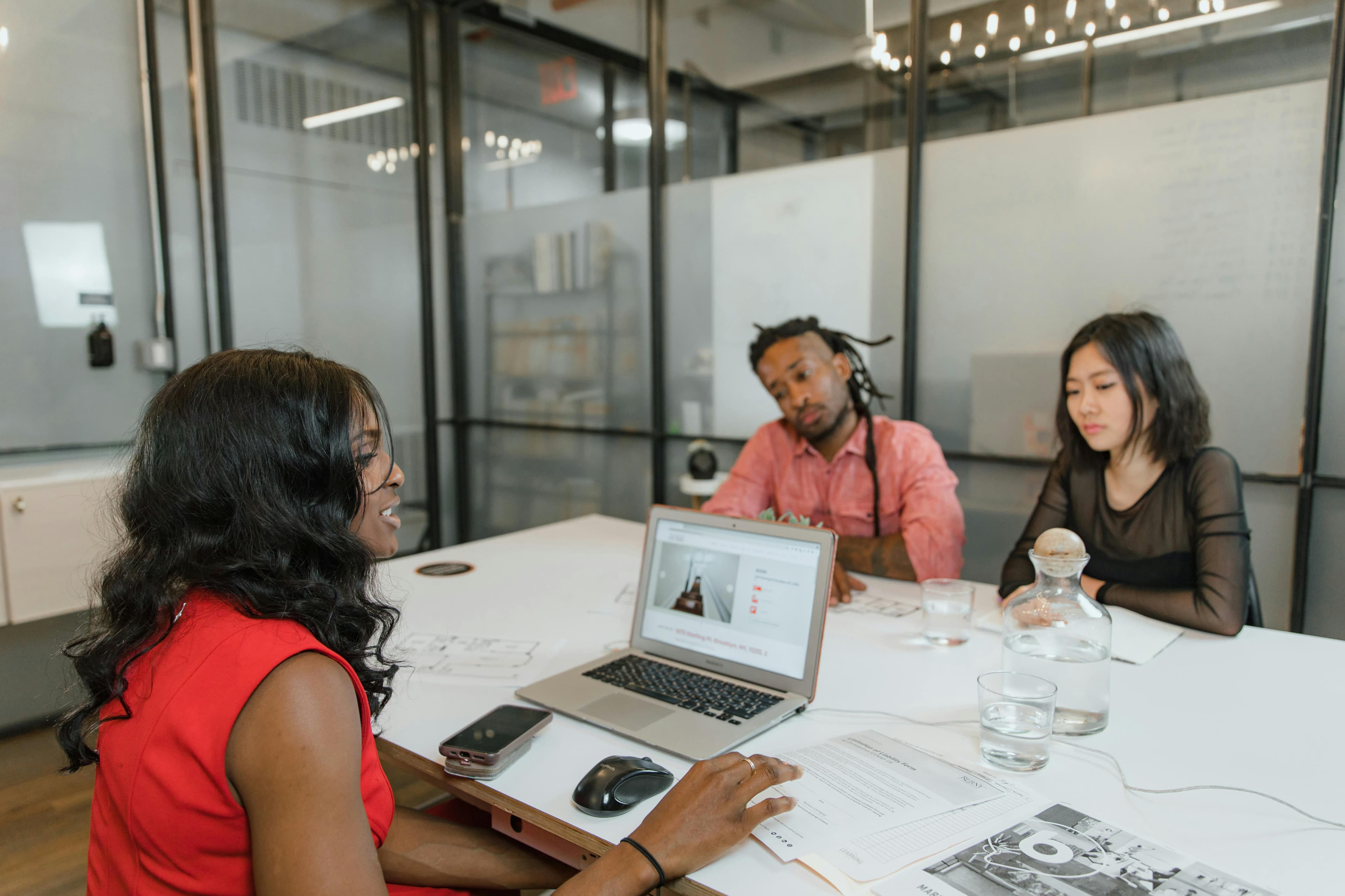Team discussing documents around a meeting table