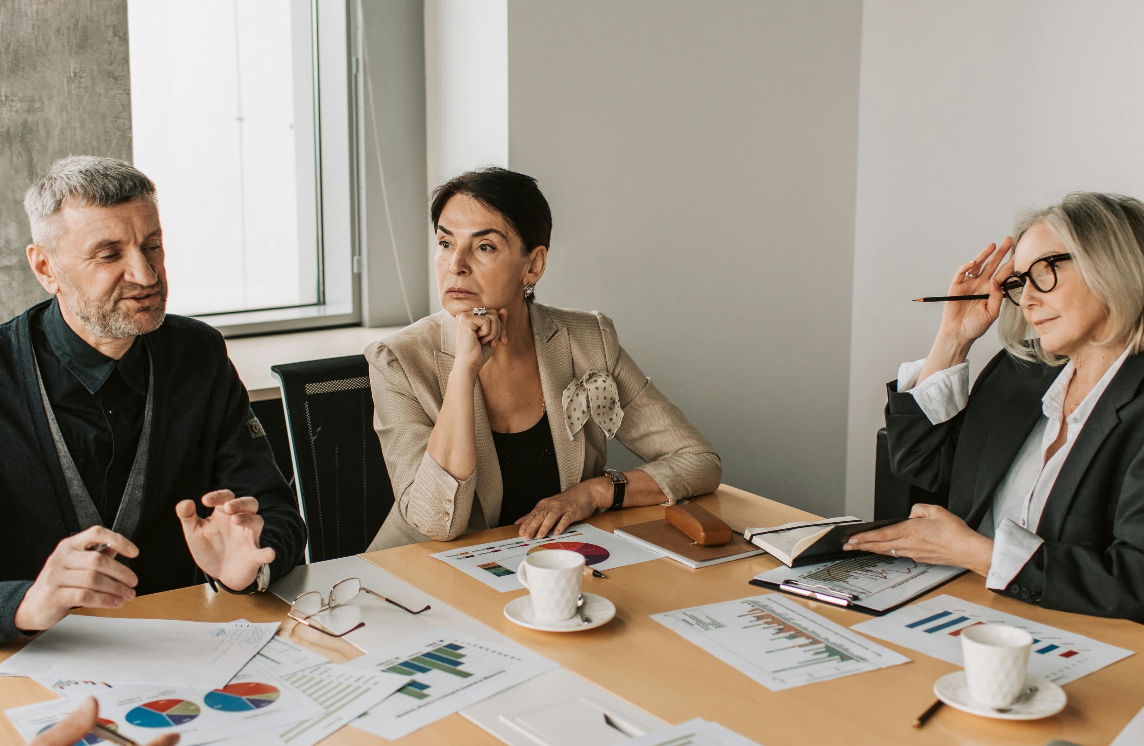 Professionals reviewing investor reporting material in a meeting room